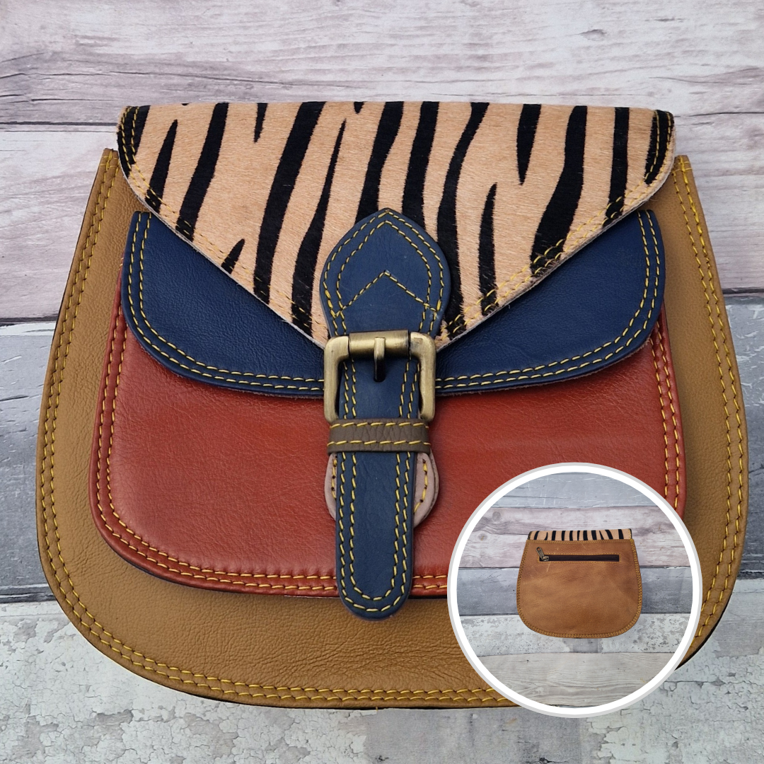 Saddlebag style bag in tan leather with contrasting coloured panels and a section of textured tiger print.