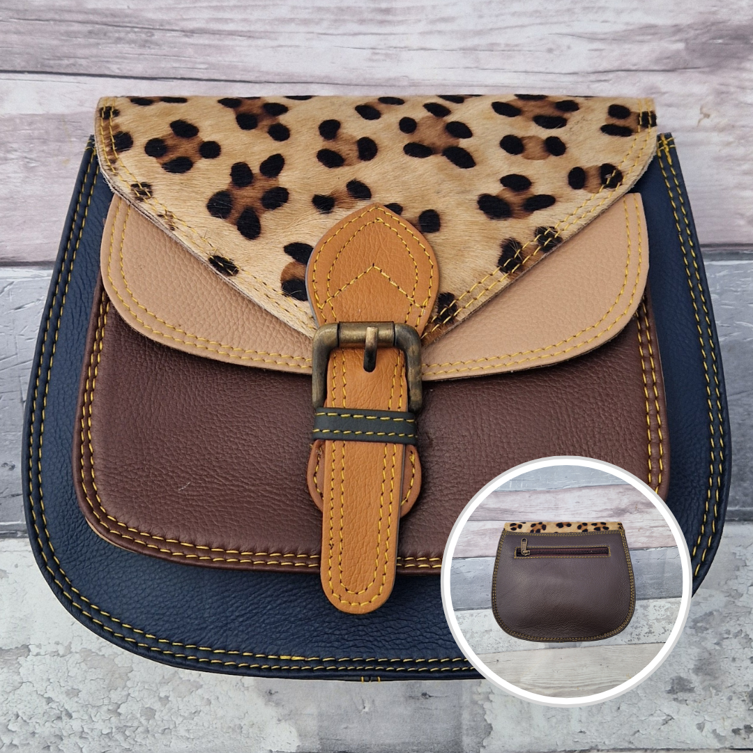 Saddlebag style bag in navy coloured leather with contrasting coloured panels and a section of textured leopard print