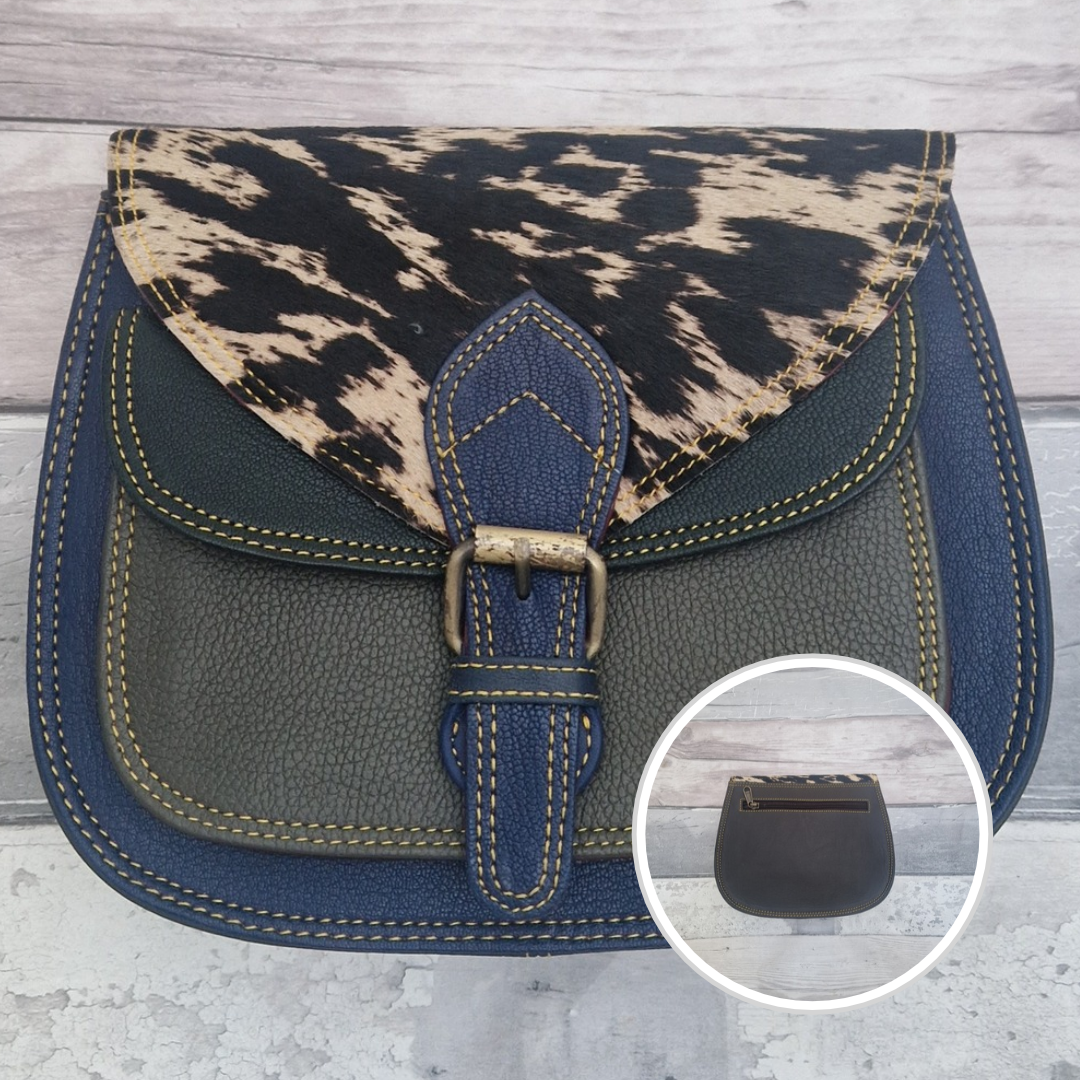 Saddlebag style bag in blue coloured leather with contrasting coloured panels and a section of textured pony Print