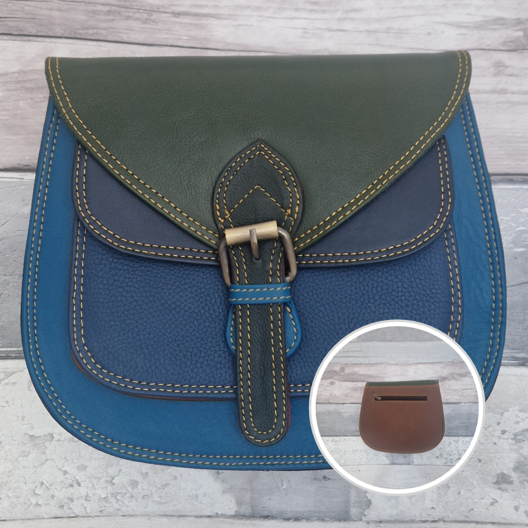 Saddlebag style bag in blue coloured leather with contrasting coloured panels in green and brown.