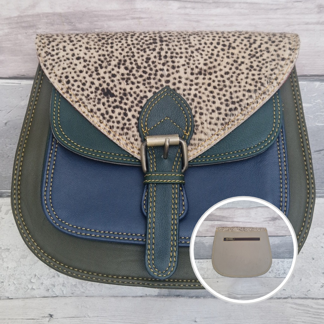 Saddlebag style bag in green coloured leather with contrasting coloured panels and a section of textured spot Print