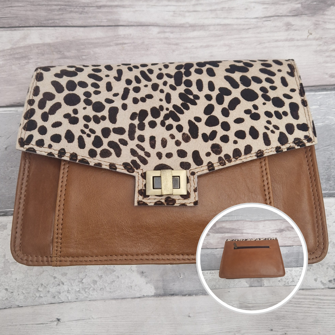 Dalmation print clutch bag with brown base on a wooden surface