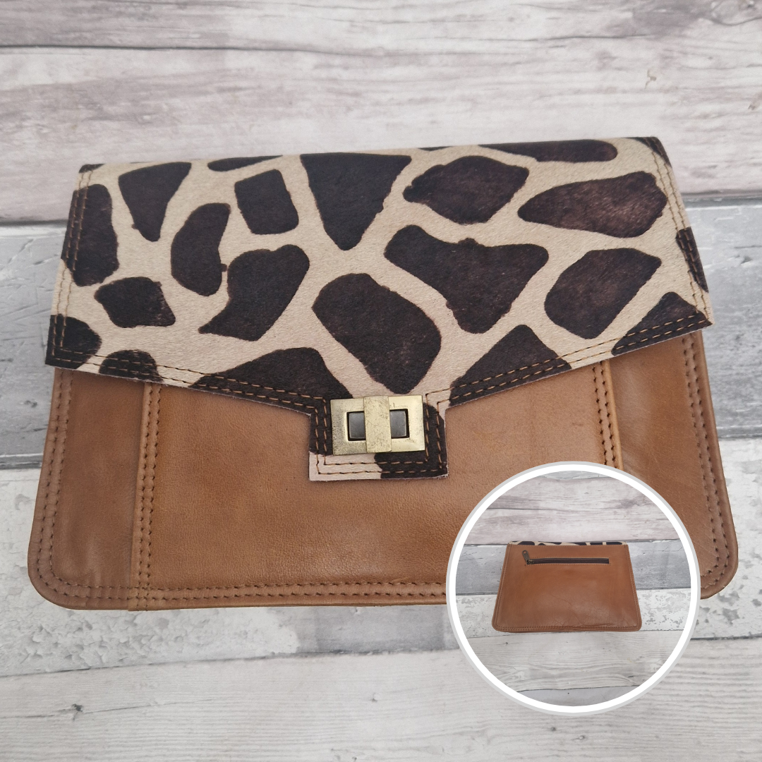 Giraffe print and brown leather wallet on a wooden surface