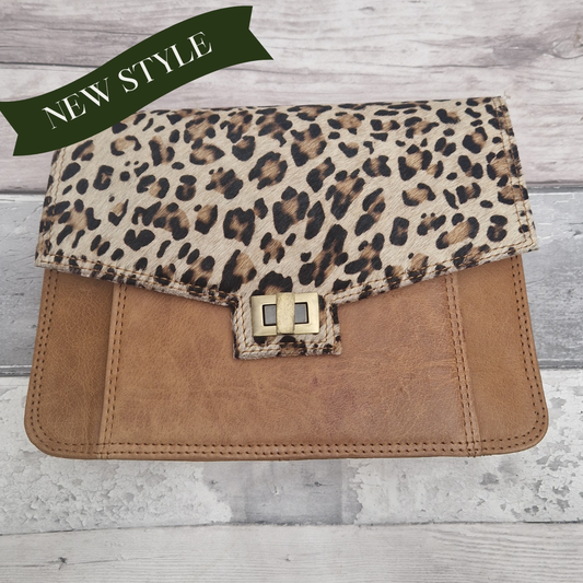 Leopard print and brown clutch bag on a wooden surface with 'NEW STYLE' banner.