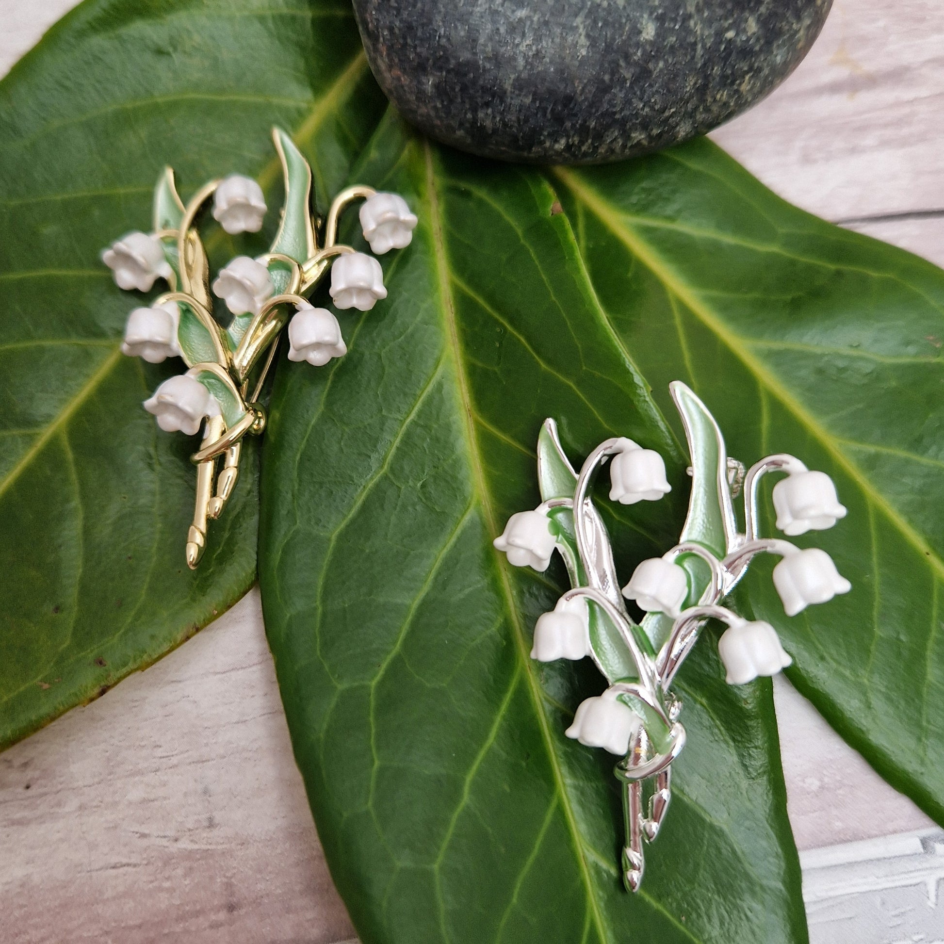 Pair of Lily of the Valley Brooches. Both hand painted, one finished in gold and one finished in silver.