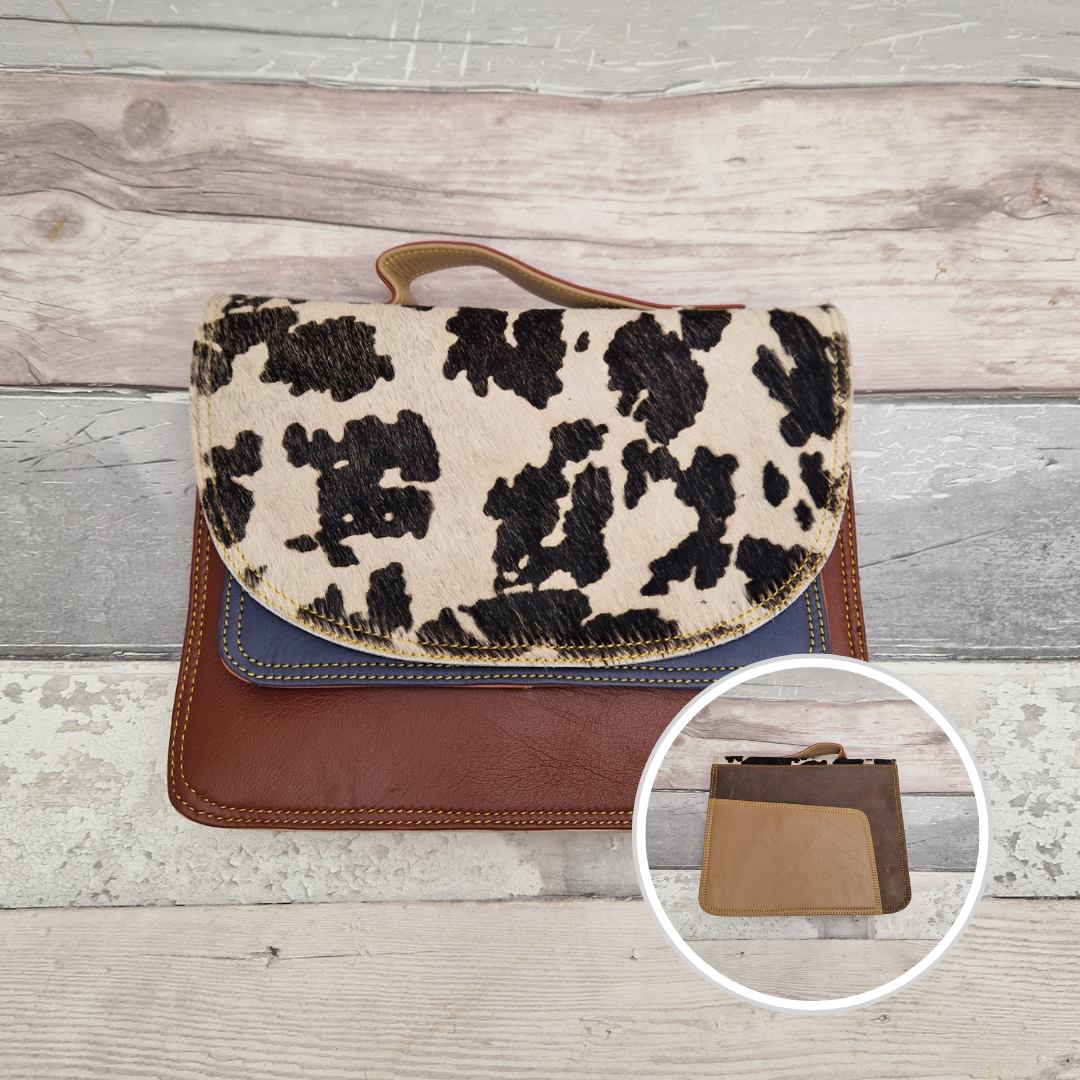 All leather bag with top handle and detachable crossbody strap. Brown leather with a striking textured panel of cow print.