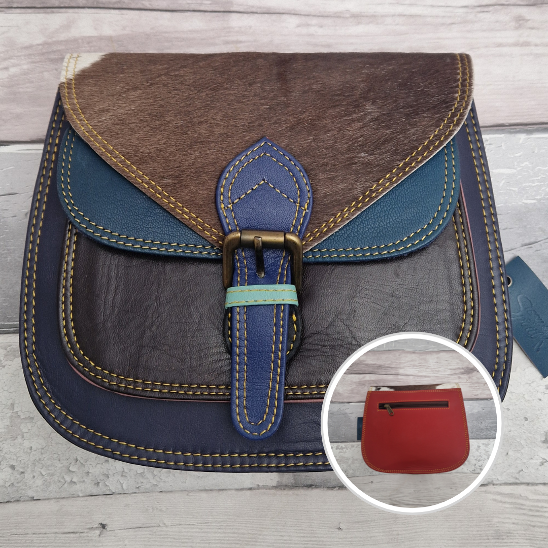 Saddlebag style bag in navy coloured leather with contrasting coloured panels and a section of textured pony Print