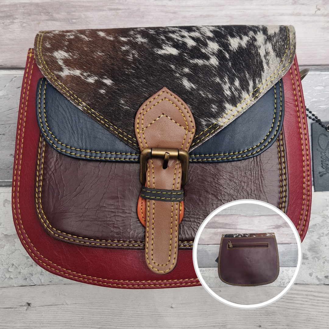 Saddlebag style bag in red coloured leather with contrasting coloured panels and a section of textured pony Print