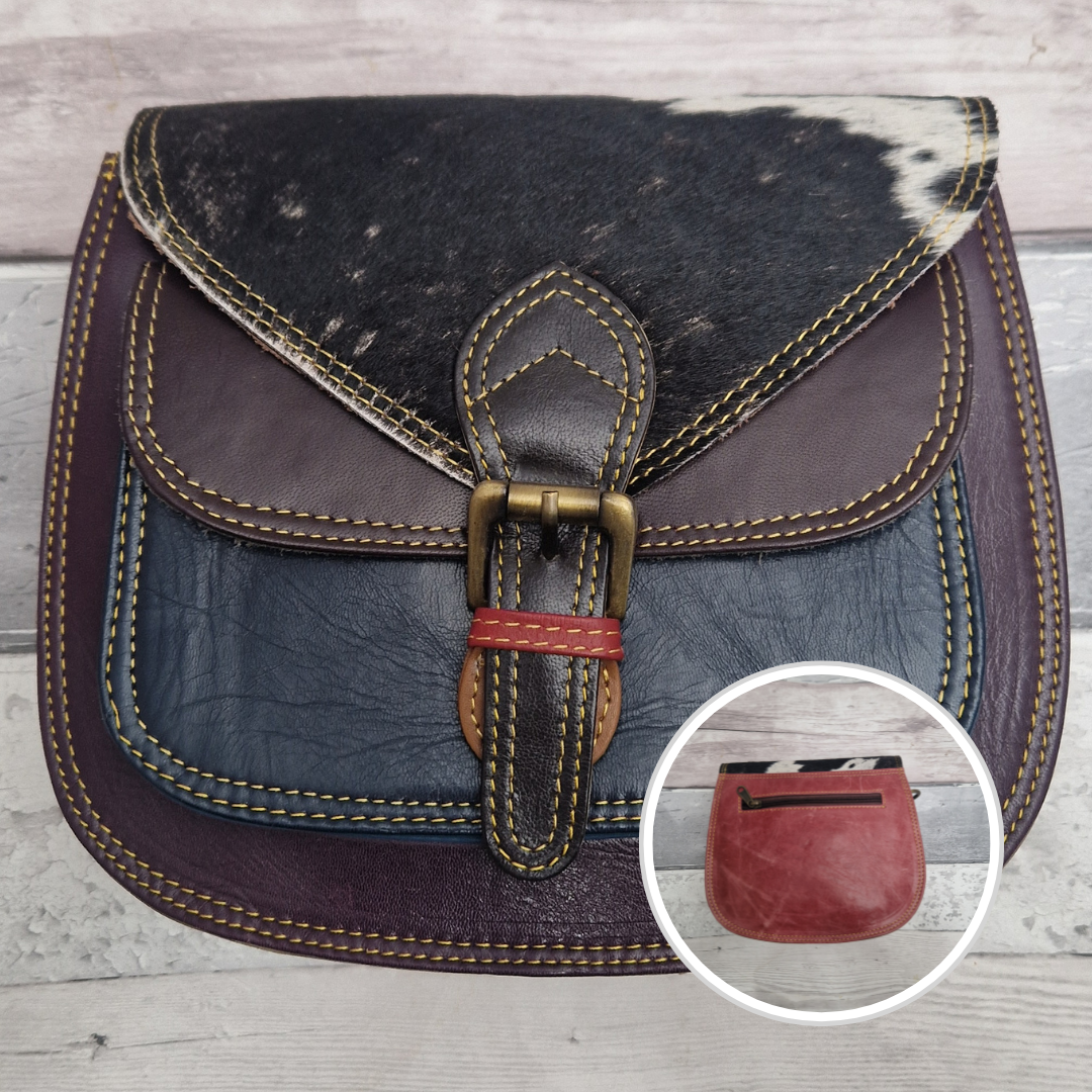 Saddlebag style bag in aubergine coloured leather with contrasting coloured panels and a section of textured spot pony print.