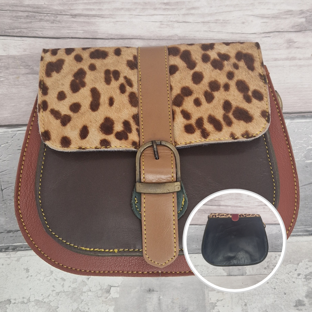 All leather saddlebag style ladies bag in 2 tones of brown with a textured panel of wild spotty print. Brass buckle closer.