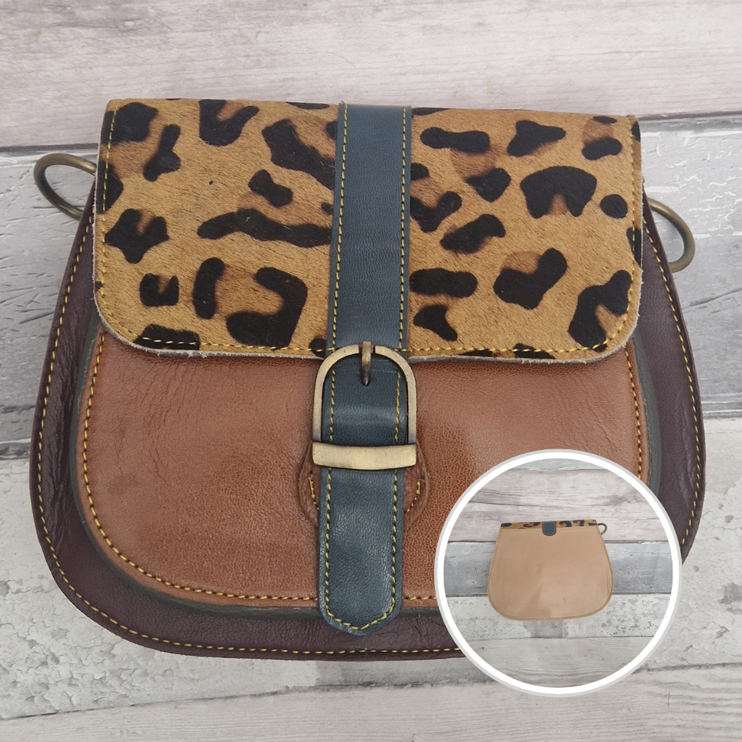 All leather saddlebag style ladies bag in 2 tones of brown and burgundy with a textured panel of leopard print. Brass buckle closer.