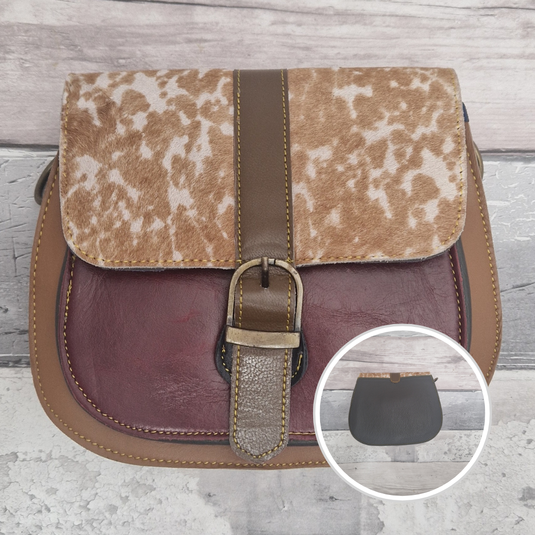 All leather saddlebag style ladies bag in 2 tones of brown and  burgundy with a textured panel of fawn print. Brass buckle closer.