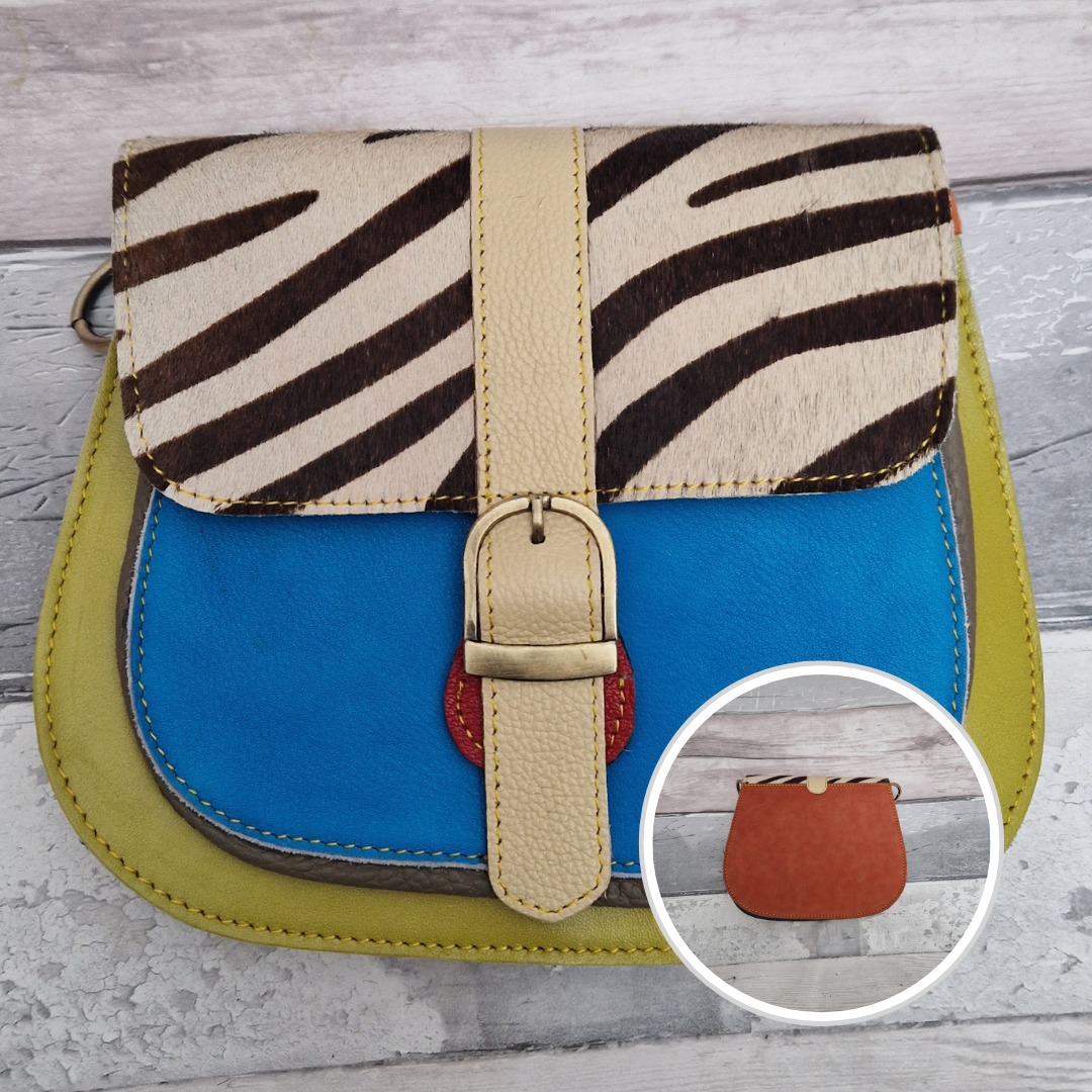 All leather saddlebag style ladies bag in 2 tones of blue and lime with a textured panel of zebra print. Brass buckle closer.