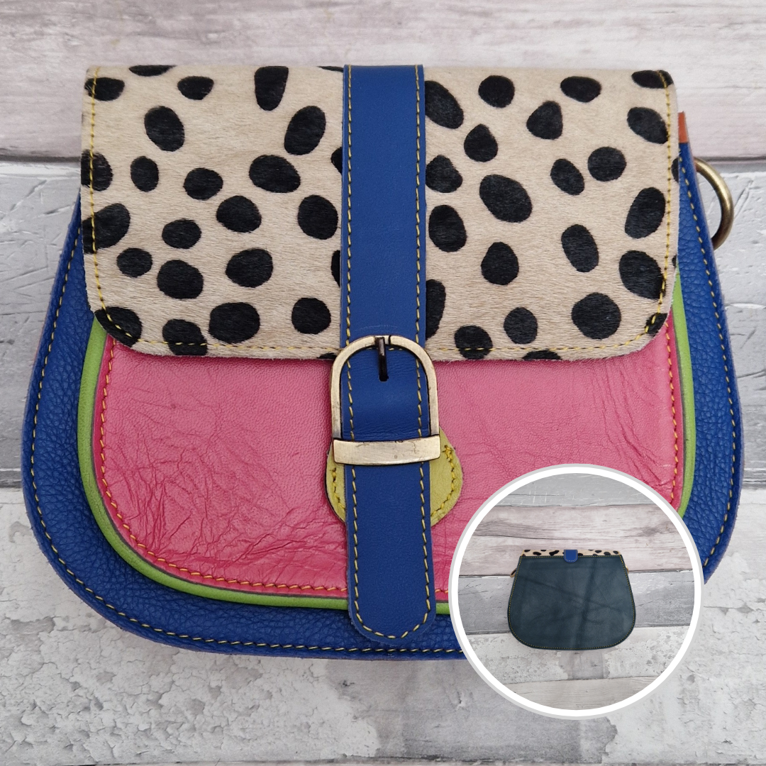 All leather saddlebag style ladies bag in 2 tones of blue and pink with a textured panel of spot print. Brass buckle closer.