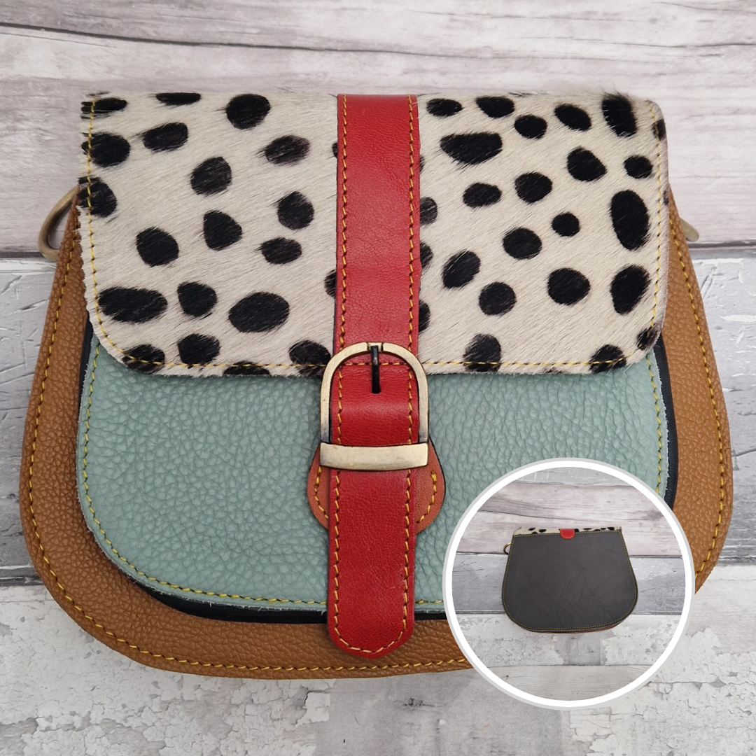 All leather saddlebag style ladies bag in 2 tones of tan and aqua with a textured panel of spot print. Brass buckle closer.