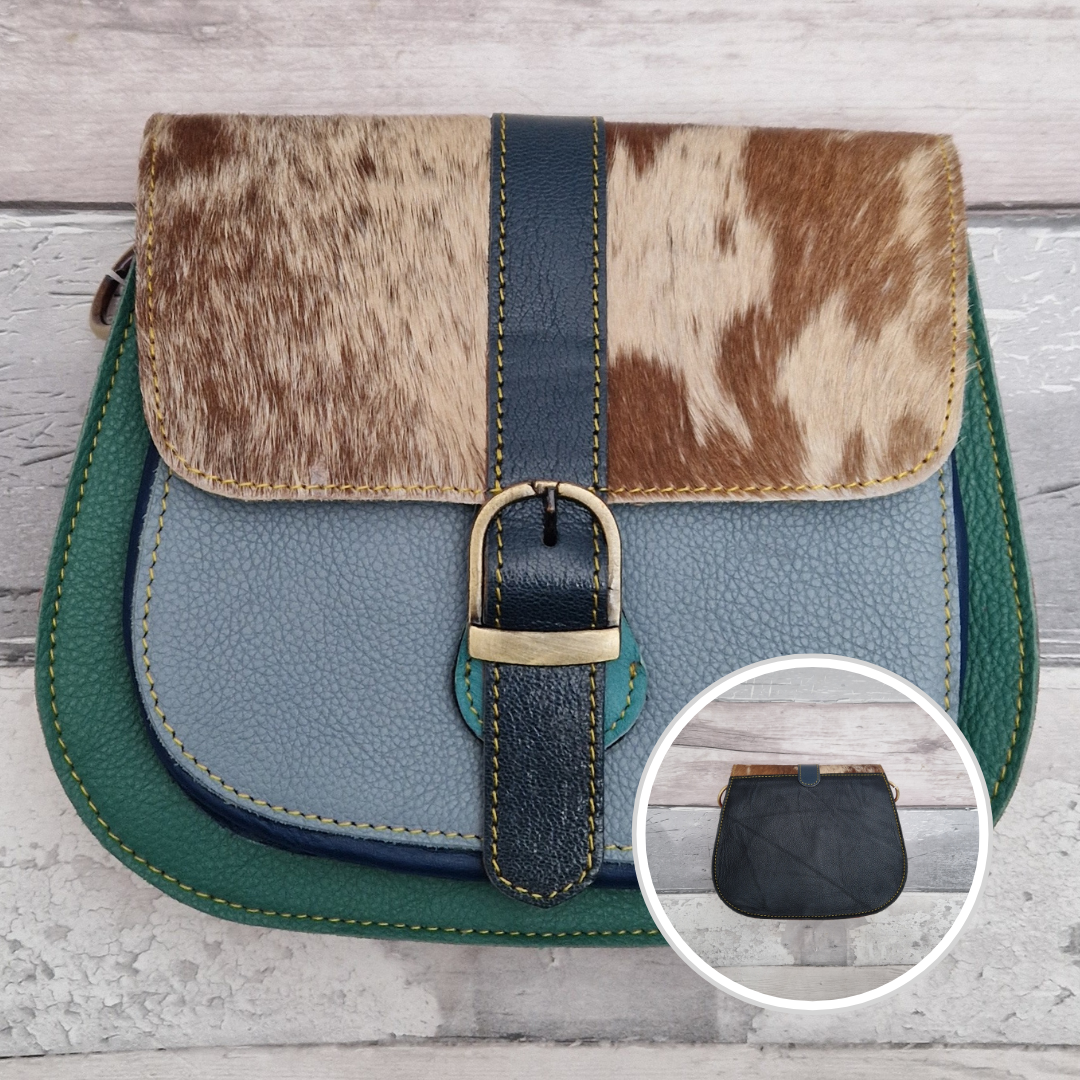 All leather saddlebag style ladies bag in 2 tones of blue and green with a textured panel of pony print. Brass buckle closer.