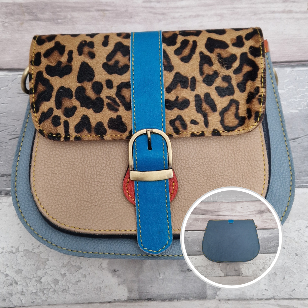 All leather saddlebag style ladies bag in 2 tones of blue and  beige with a textured panel of leopard print. Brass buckle closer.