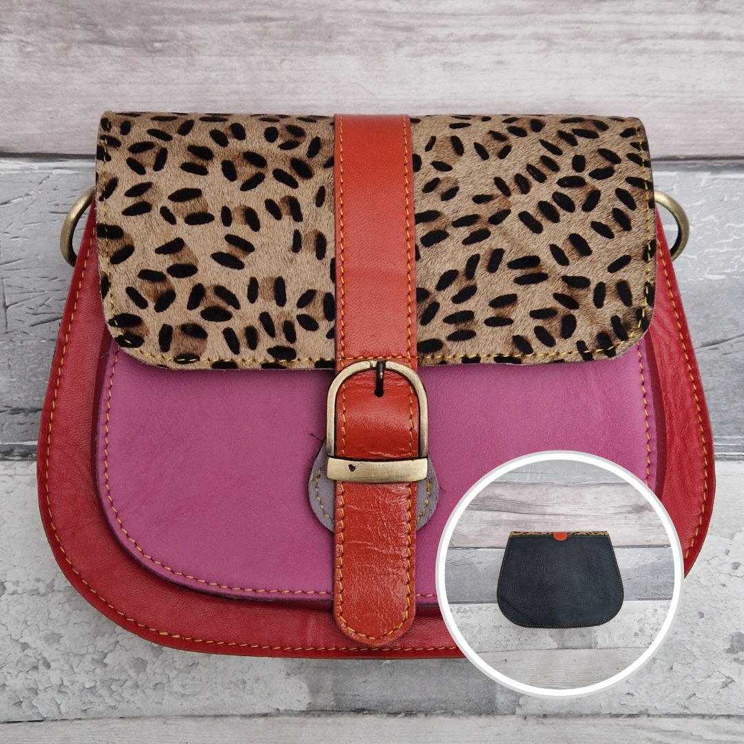 All leather saddlebag style ladies bag in 2 tones of pink and red with a textured panel of leopard print. Brass buckle closer.