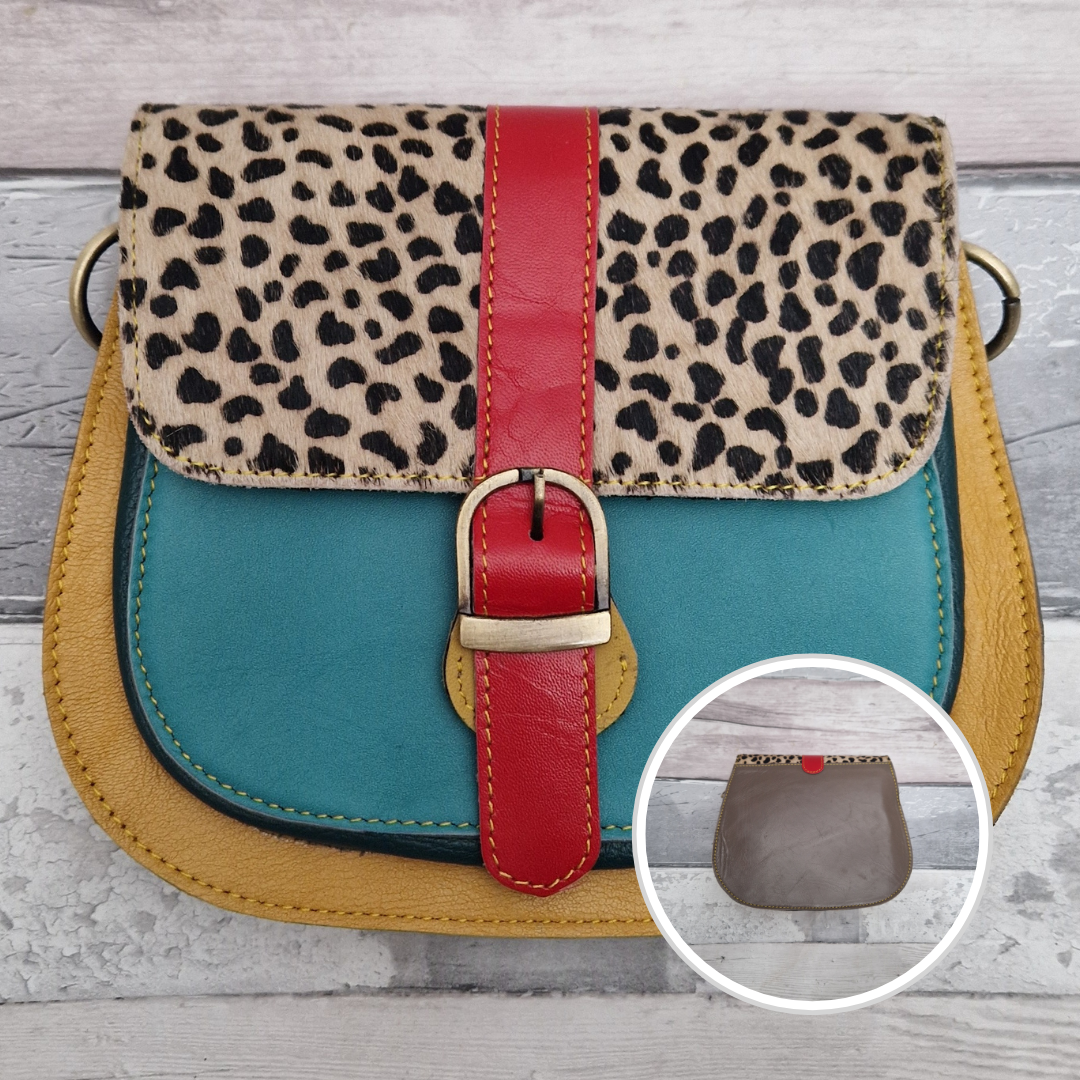 All leather saddlebag style ladies bag in 2 tones of red, turquoise and mustard with a textured panel of lynx print. Brass buckle closer.