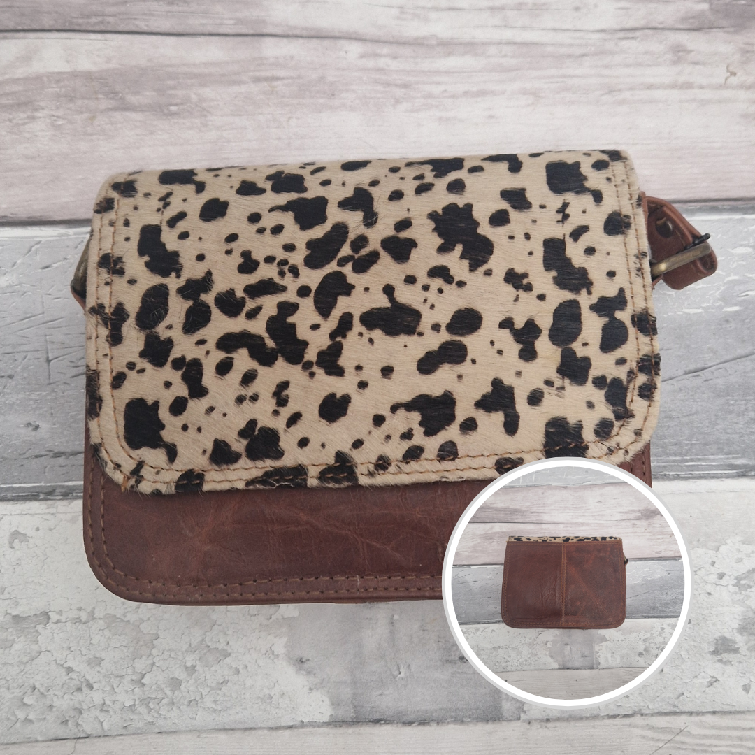 Leather bag with a textured flap of cow print.
