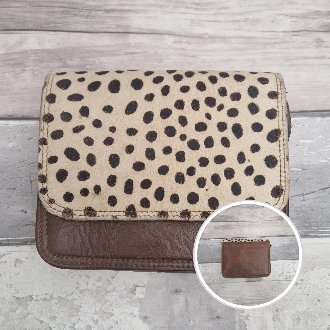 Leather bag with a textured flap of spot print.