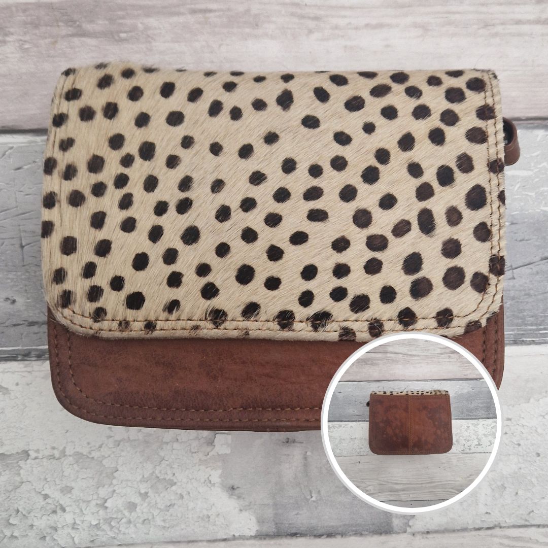 Leather bag with a textured flap of spot print.