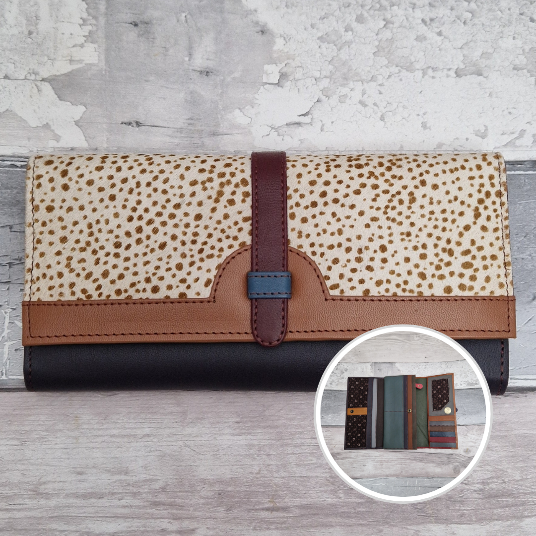 All leather fold out purse made from a mix of colours with a textured front panel of spot print.