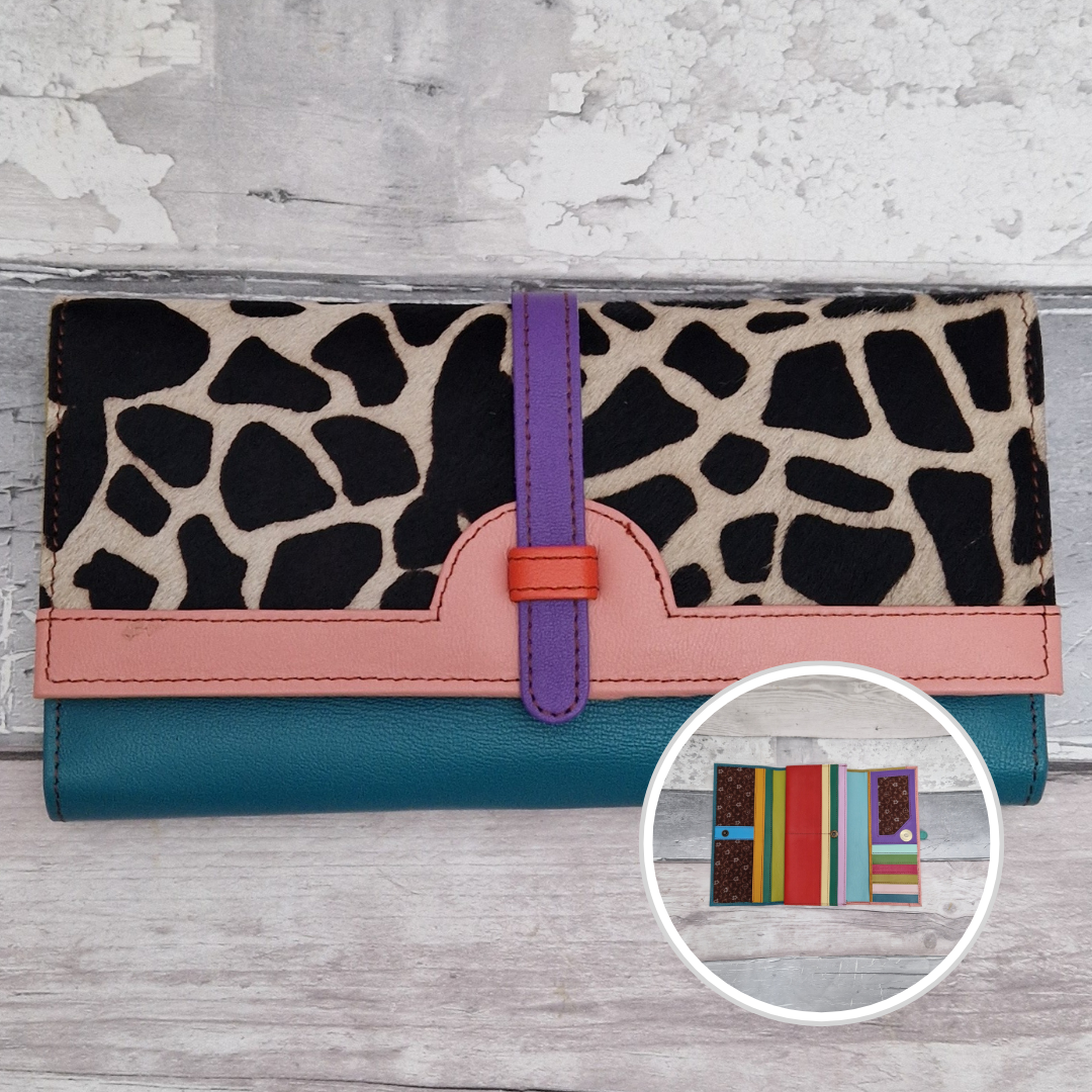 All leather fold out purse made from a rainbow of colours with a textured front panel of giraffe print.