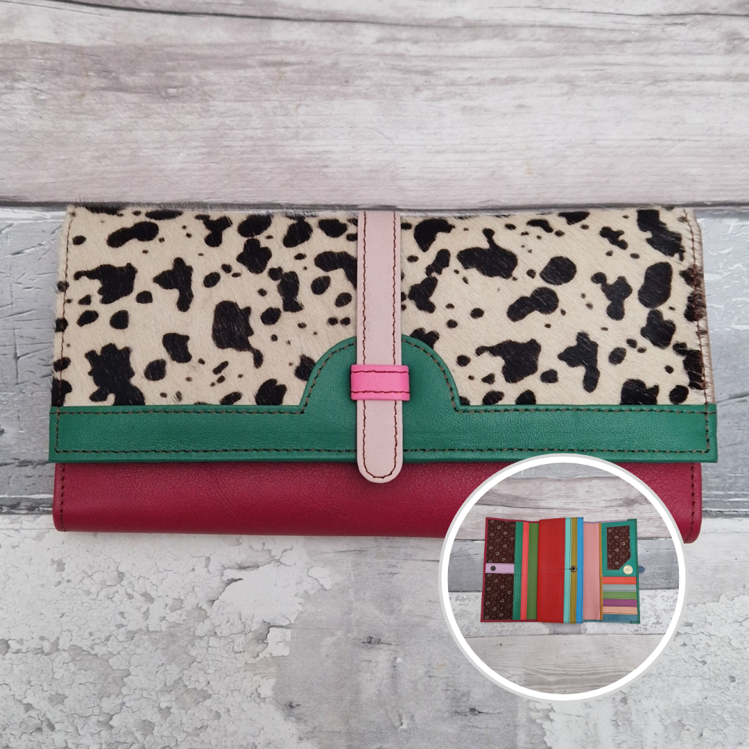 All leather fold out purse made from a rainbow of colours with a textured front panel of cow print.