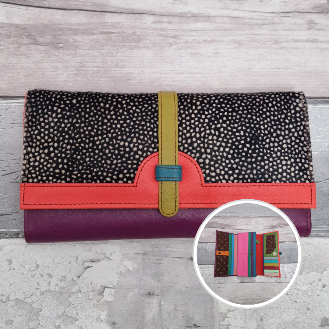 All leather fold out purse made from a rainbow of colours with a textured front panel of dark spot print.