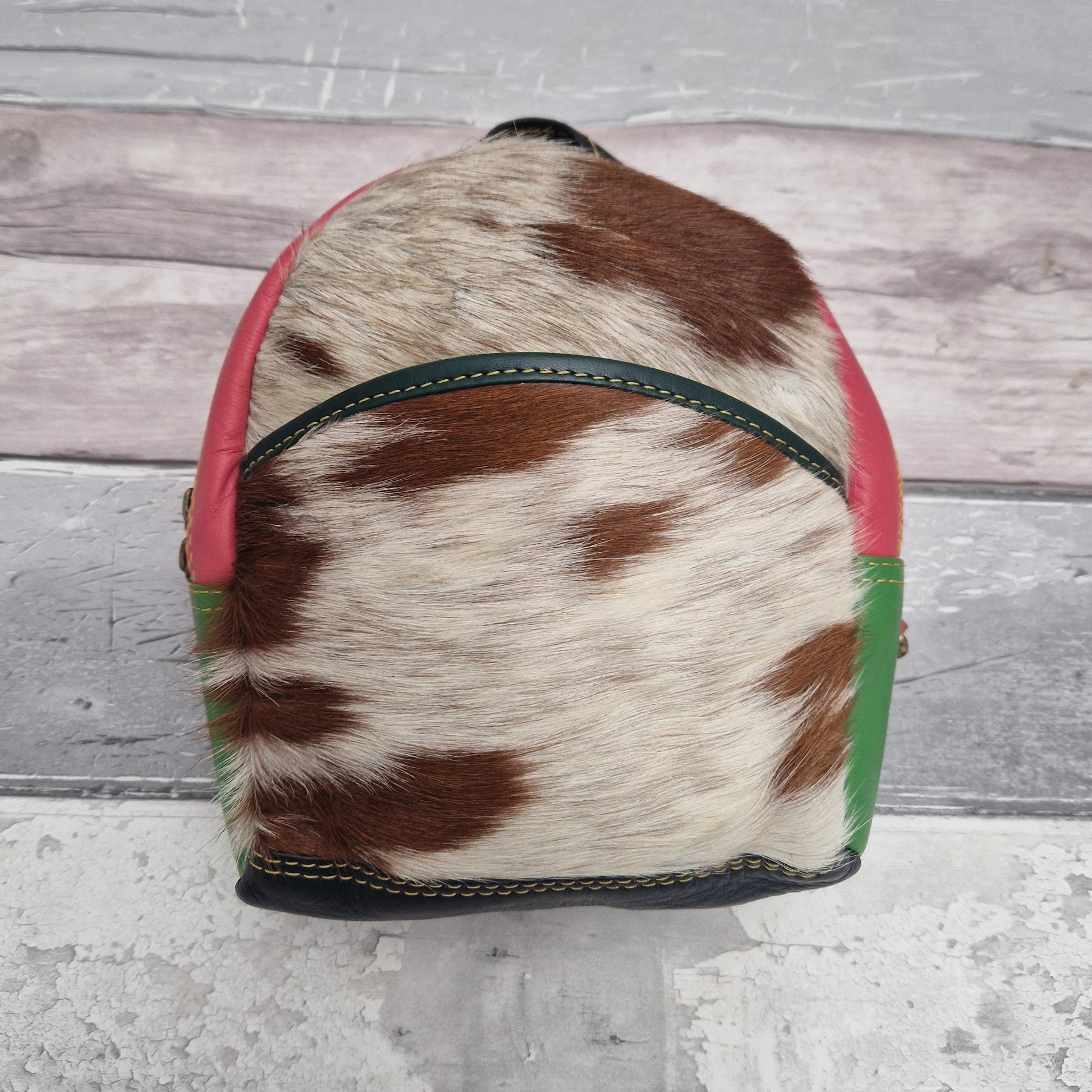 3 in 1 Mini Crossbody, Shoulder, Back Pack made from leather off-cuts in a mix of colours with a front panel of textured animal print.