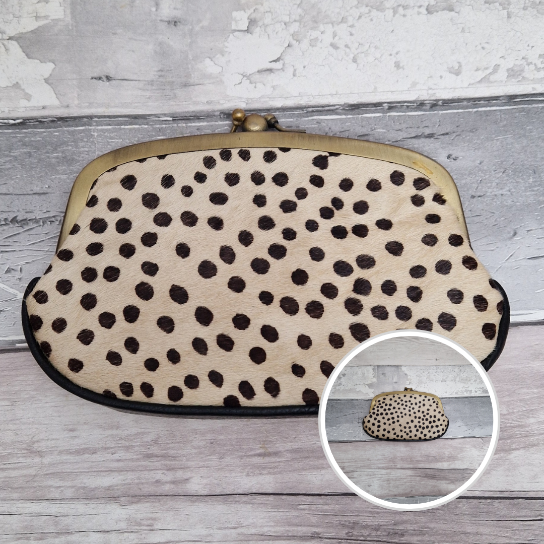 Clutch bag with spot print on a wooden surface