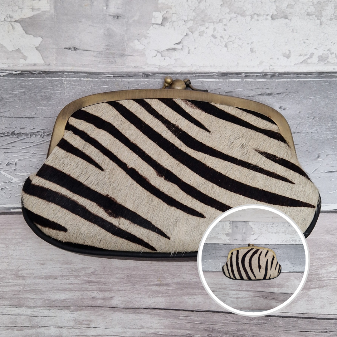 Clutch bag with zebra pattern on a wooden surface