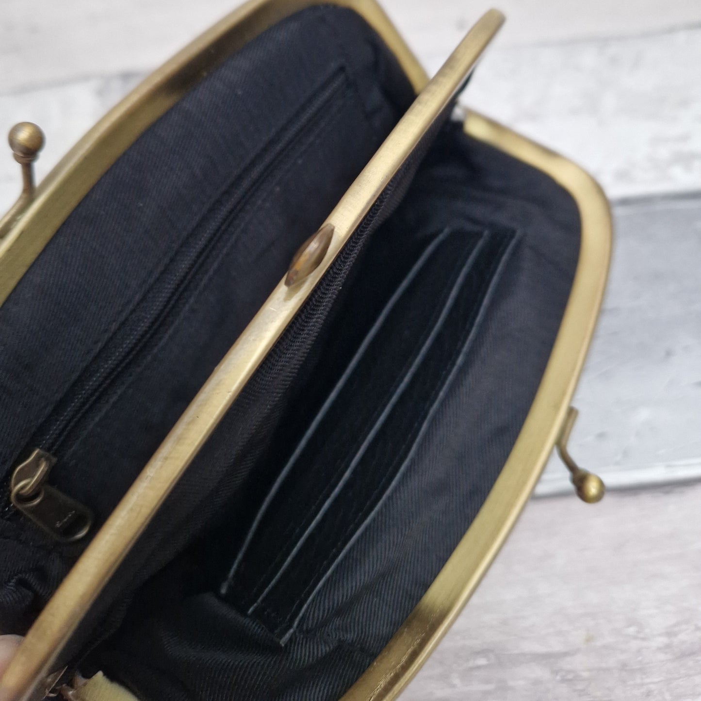 Inside view of a clutch bag with 2 compartments.