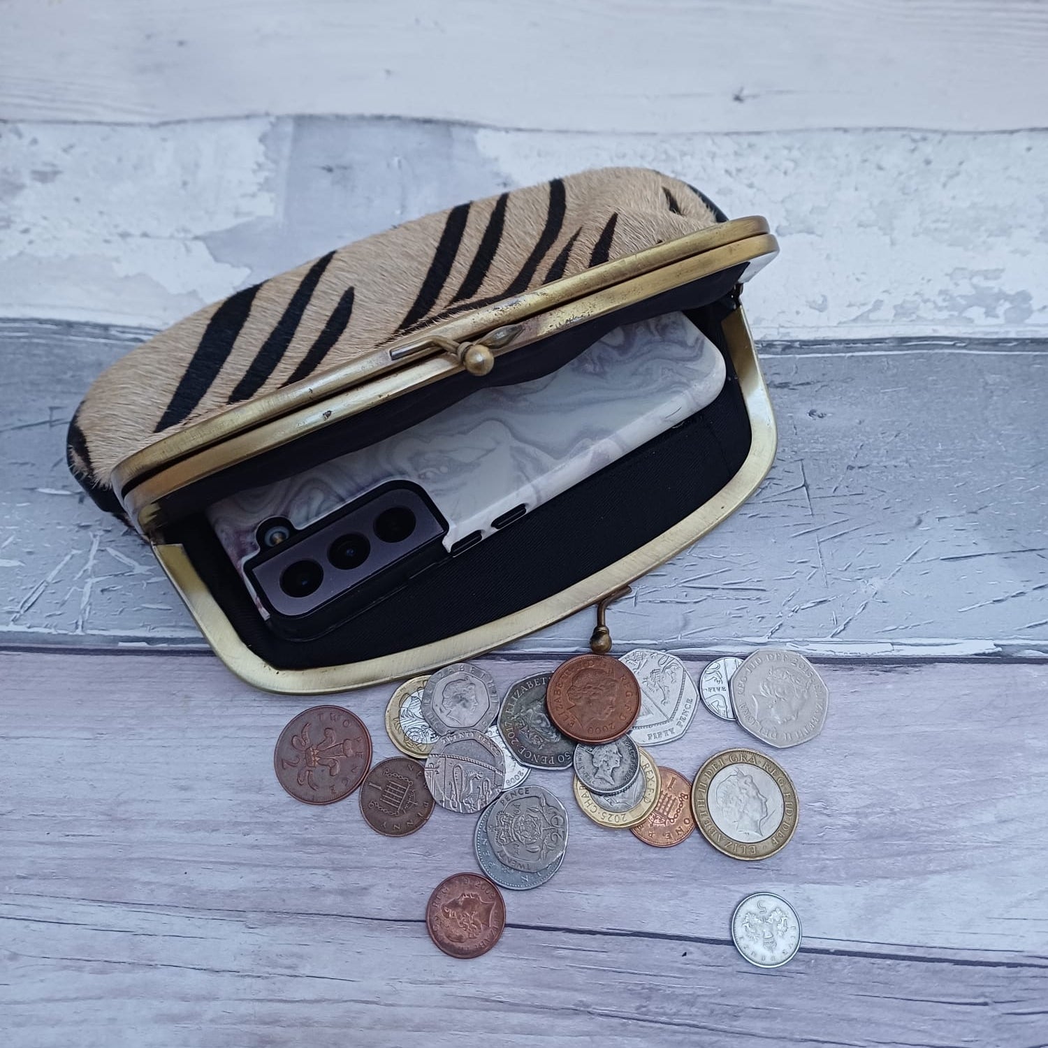 Inside view of Nisha Clutch bag showing mobile phone.