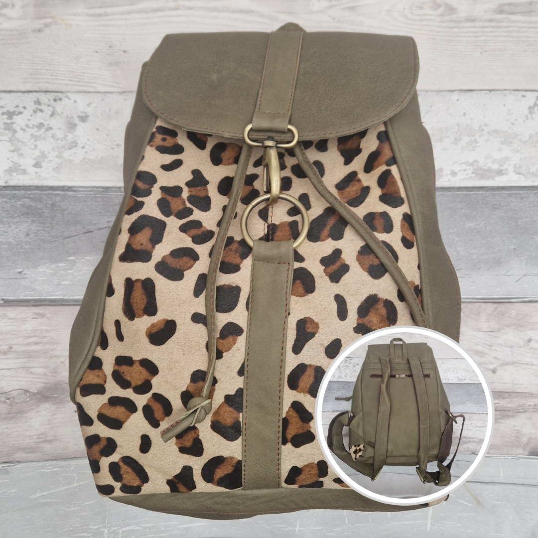Green leather backpack with leopard print pattern.