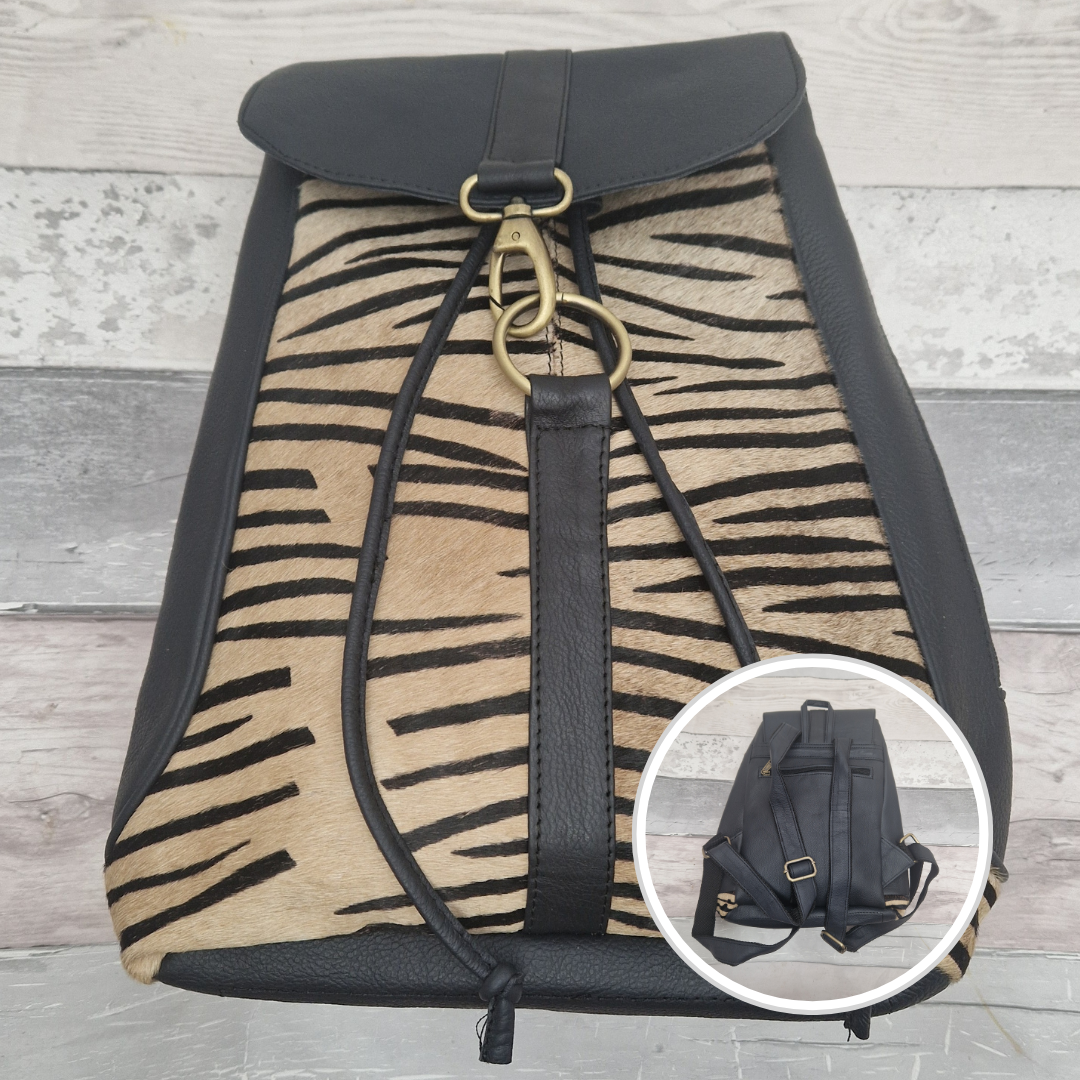Dark navy all leather back pack with textured panels of zebra print.