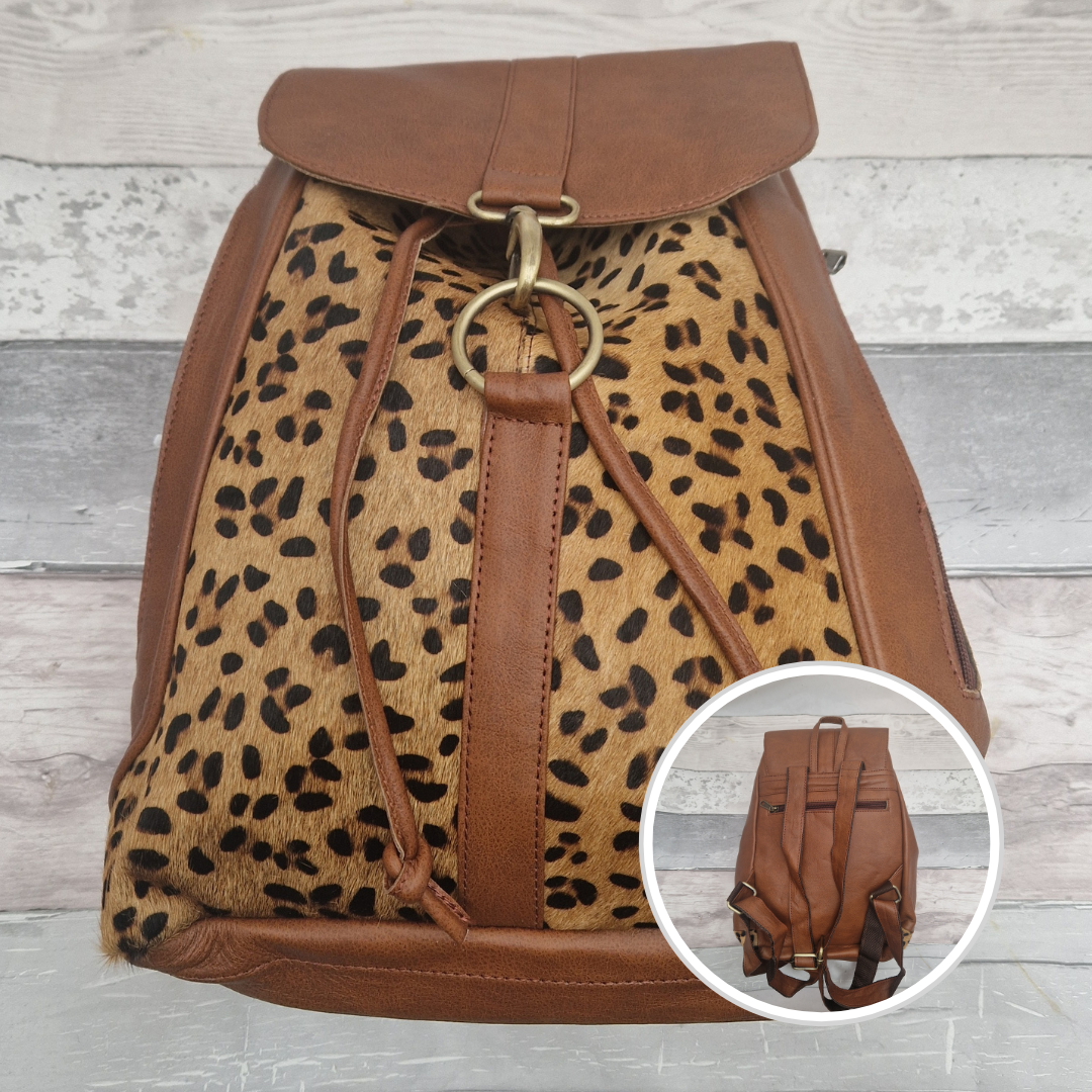 Brown all leather back pack with textured panels of leopard print.