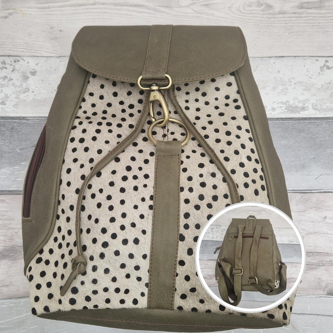 Green leather back pack with textured spotty print panels.
