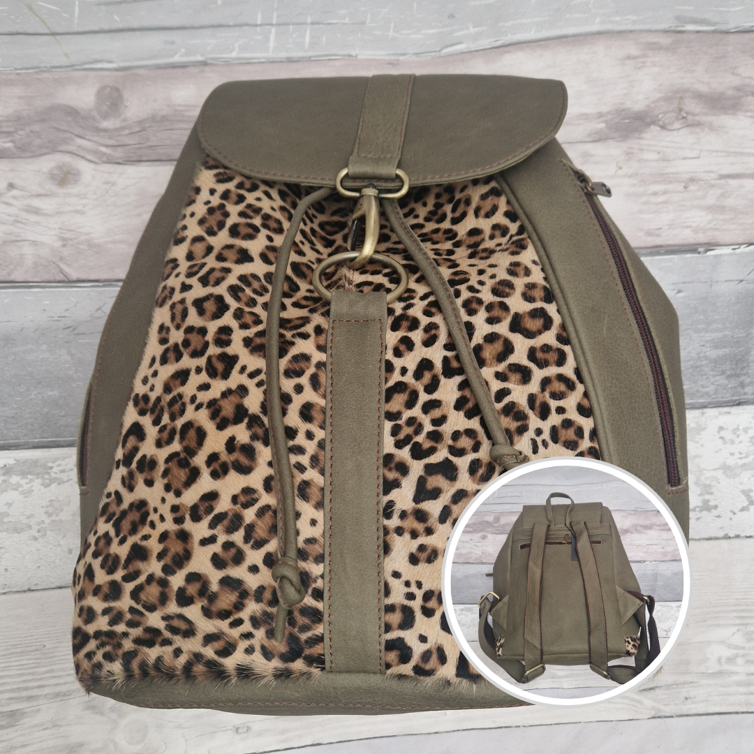 All leather green back pack with textured panels of leopard print.