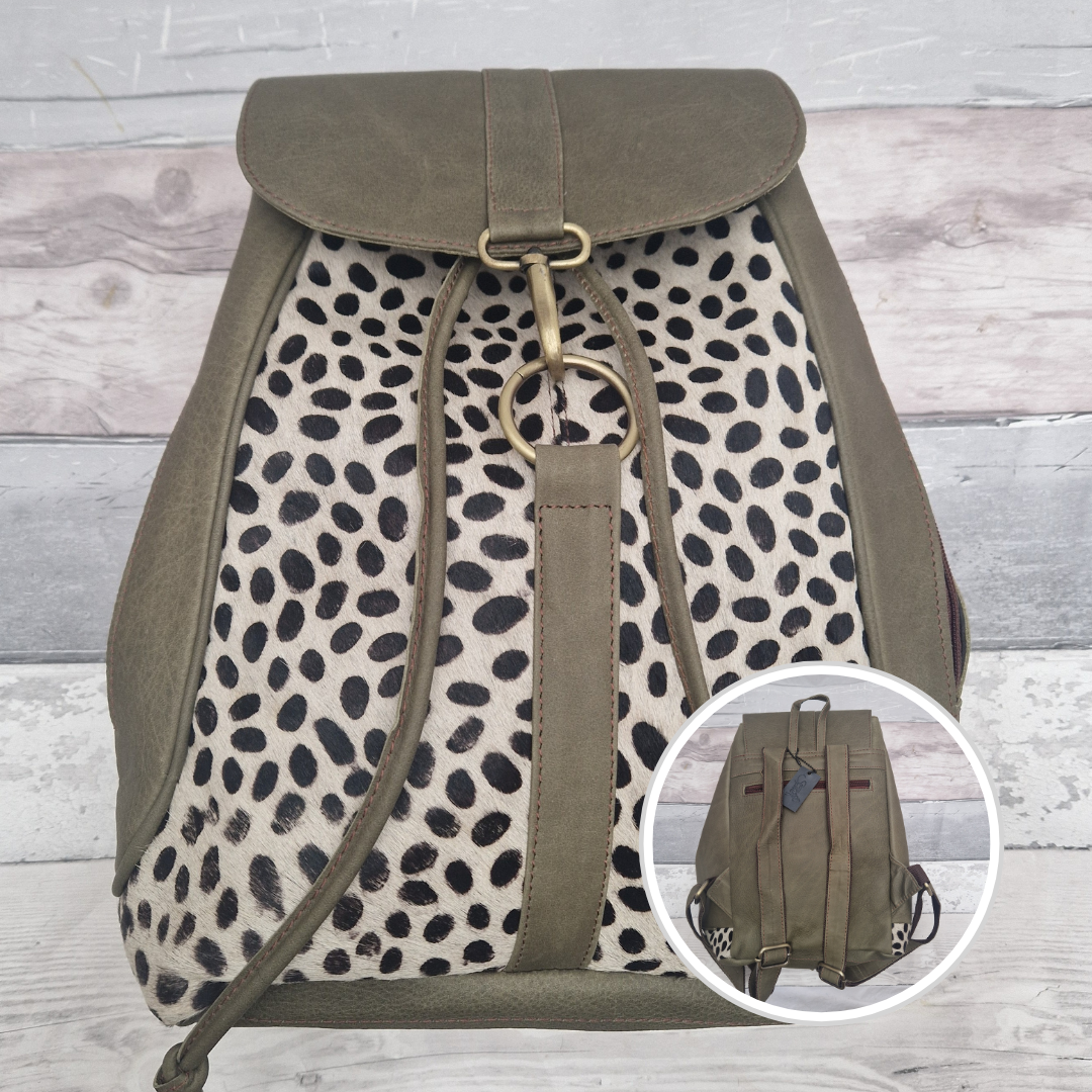 All leather green back pack with textured panels of spotty print.