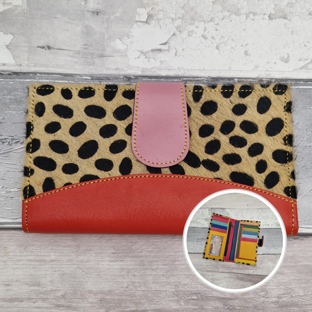 All leather wallet style purse made from multi-coloured pieces with a red front panel and textured spot print cover.