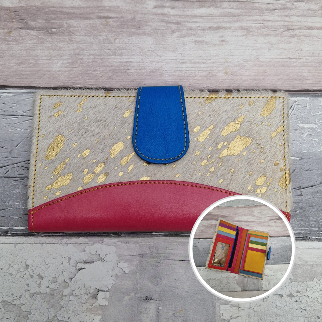 All leather wallet style purse made from multi-coloured pieces with a hot pink front panel and textured gold metallic pony print cover.