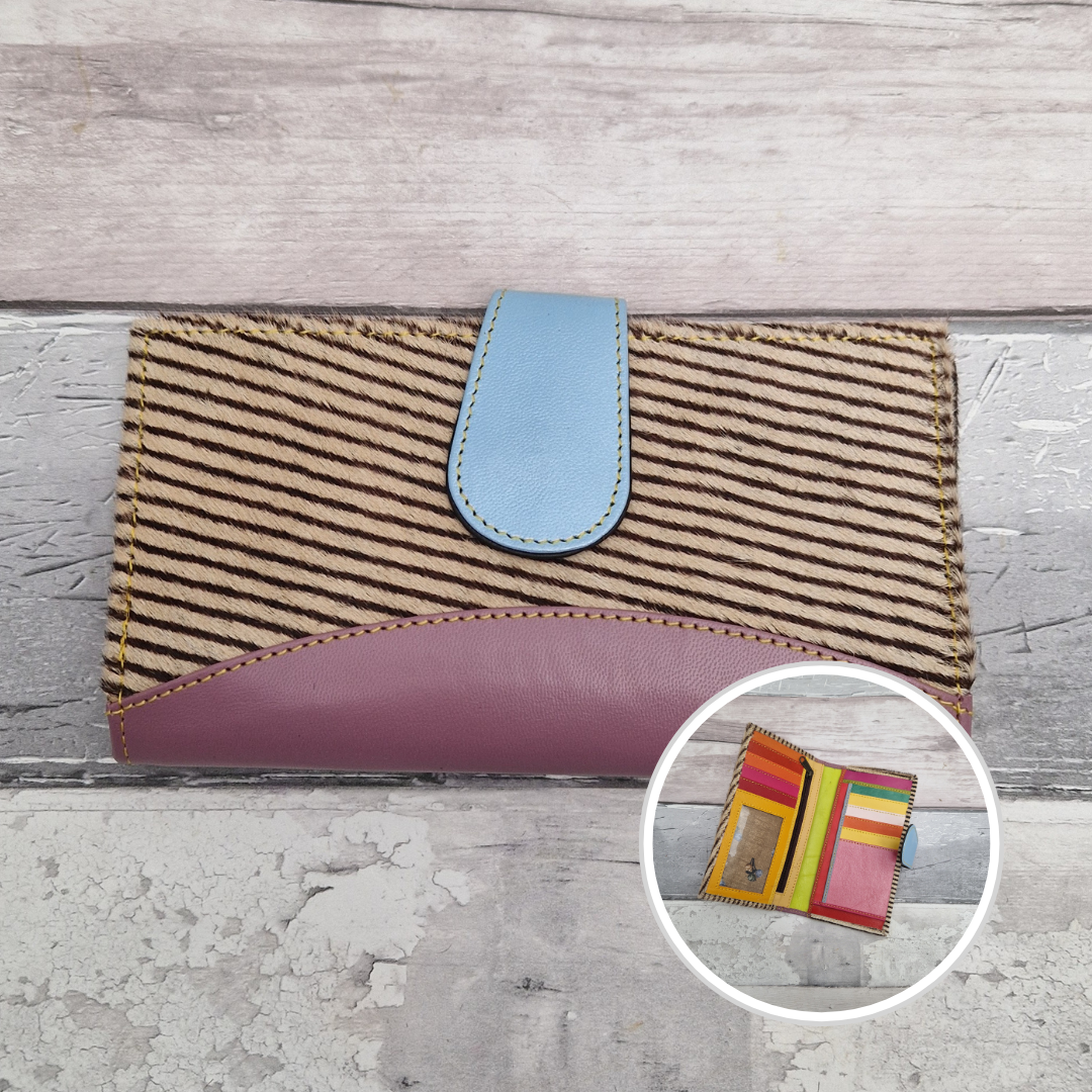 All leather wallet style purse made from multi-coloured pieces with a lilac front panel and textured stripe print cover.