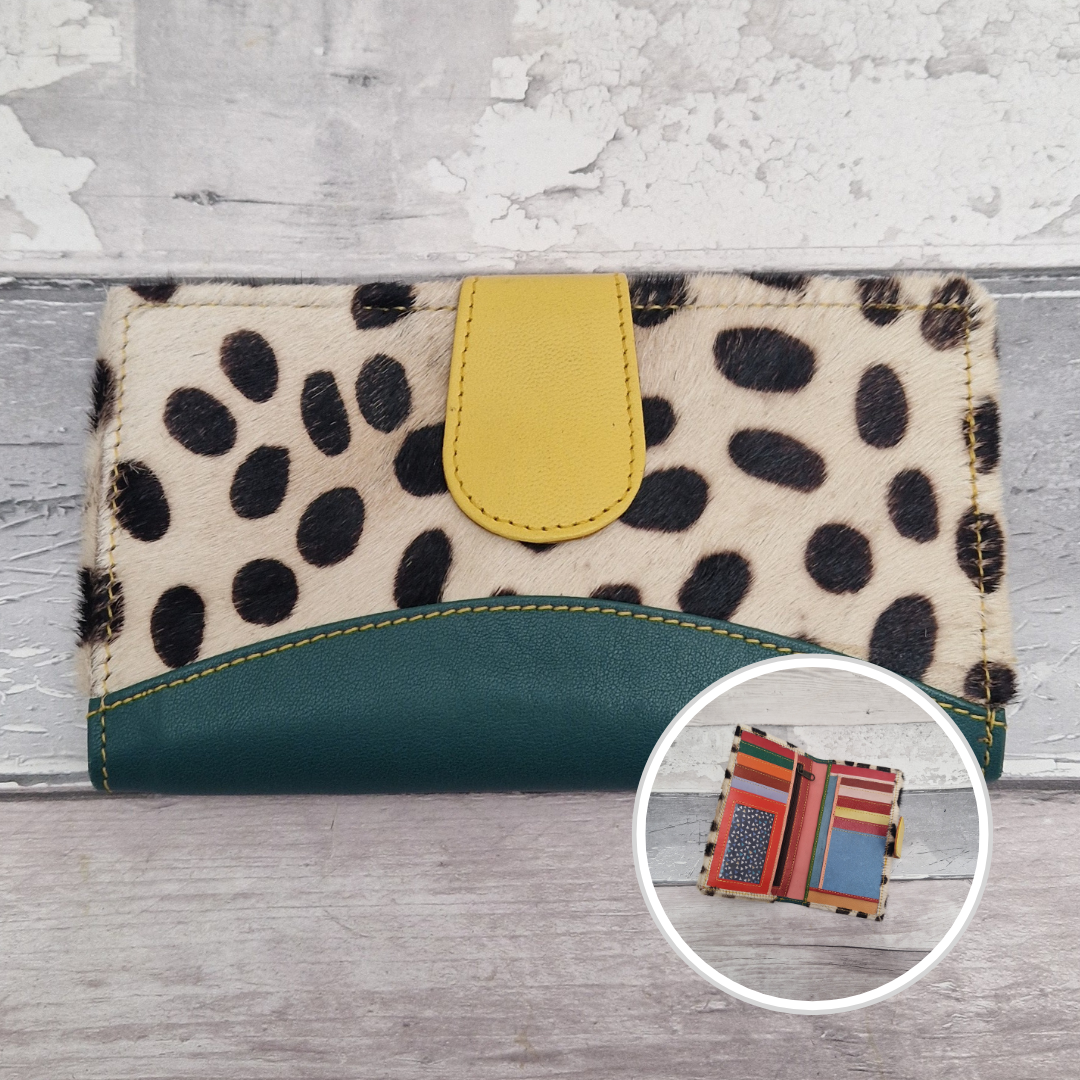 All leather wallet style purse made from multi-coloured pieces with a green front panel and textured spot print cover.