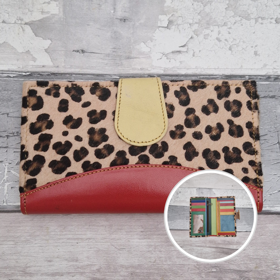 All leather wallet style purse made from multi-coloured pieces with a red front panel and textured leopard print cover.