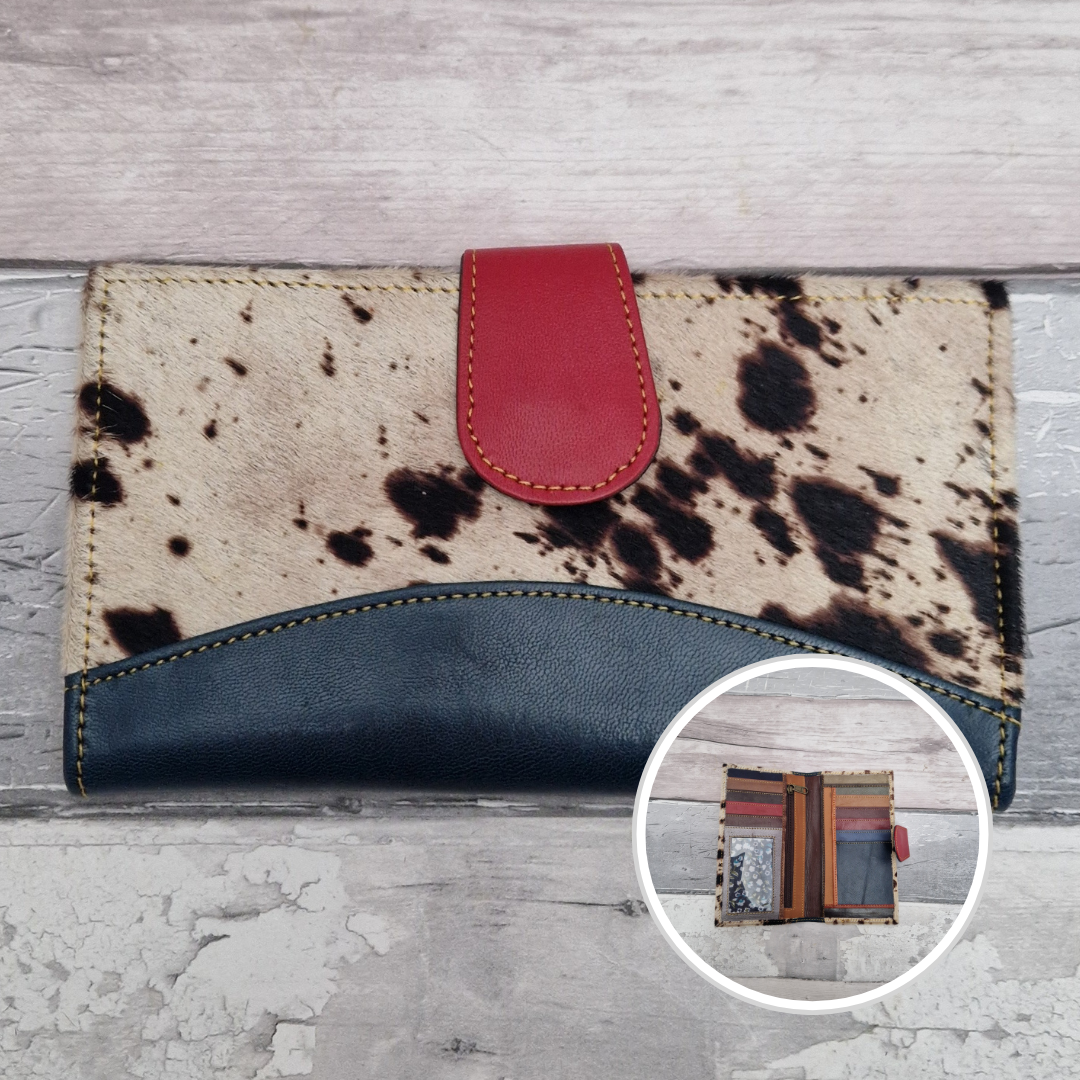 All leather wallet style purse made from multi-coloured pieces with a navy front panel and textured pony print cover.