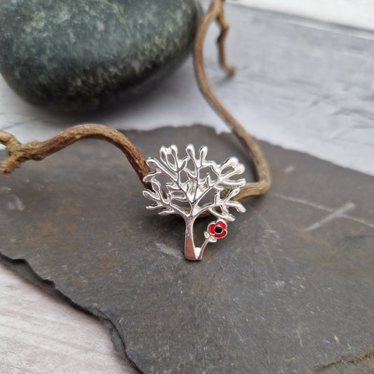 Silver Tree of Life Lapel Pin finished with a single red poppy growing from it's base.
