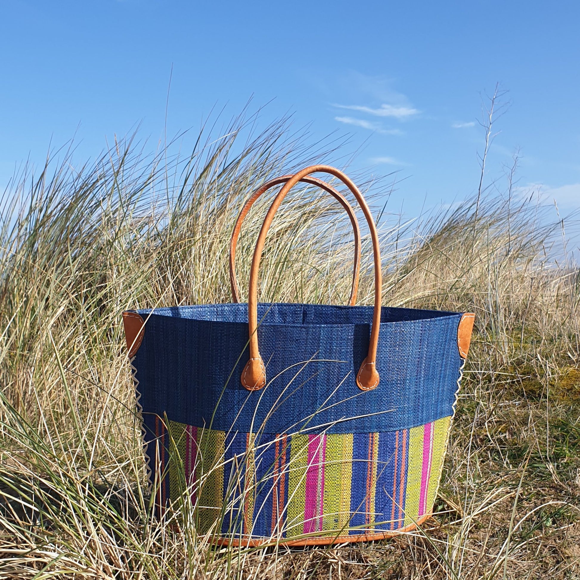 Blue Raffia basket with rainbow stripes.