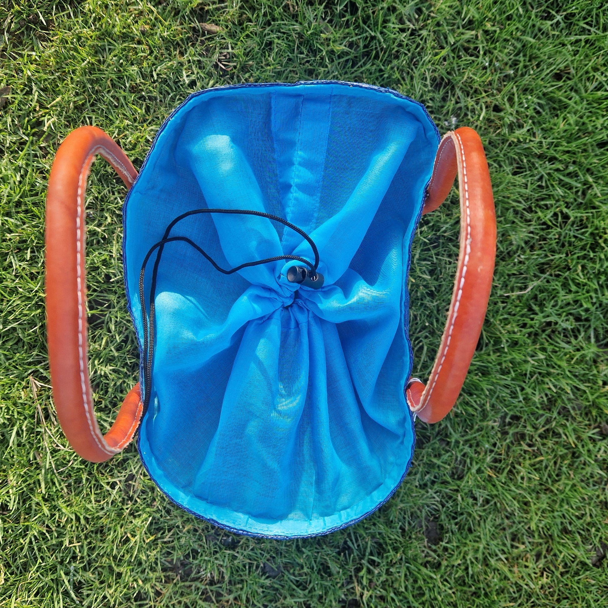 Blue basket with a drawstring top. 